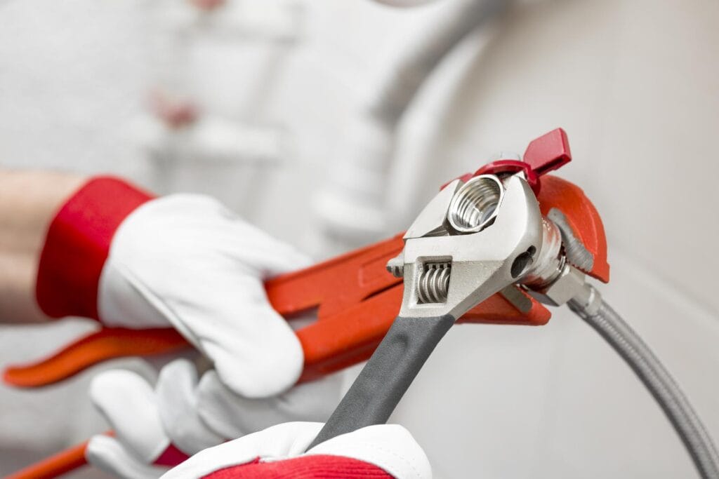 Plumber holding pipe wrenches for an emergency repair in Fleming Island