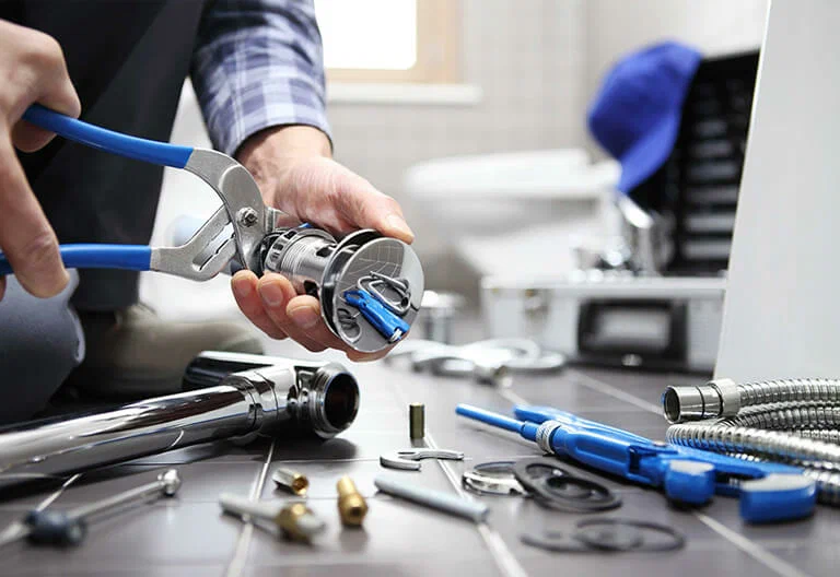 Technician repairing a plumbing fixture with professional tools in Fleming Island