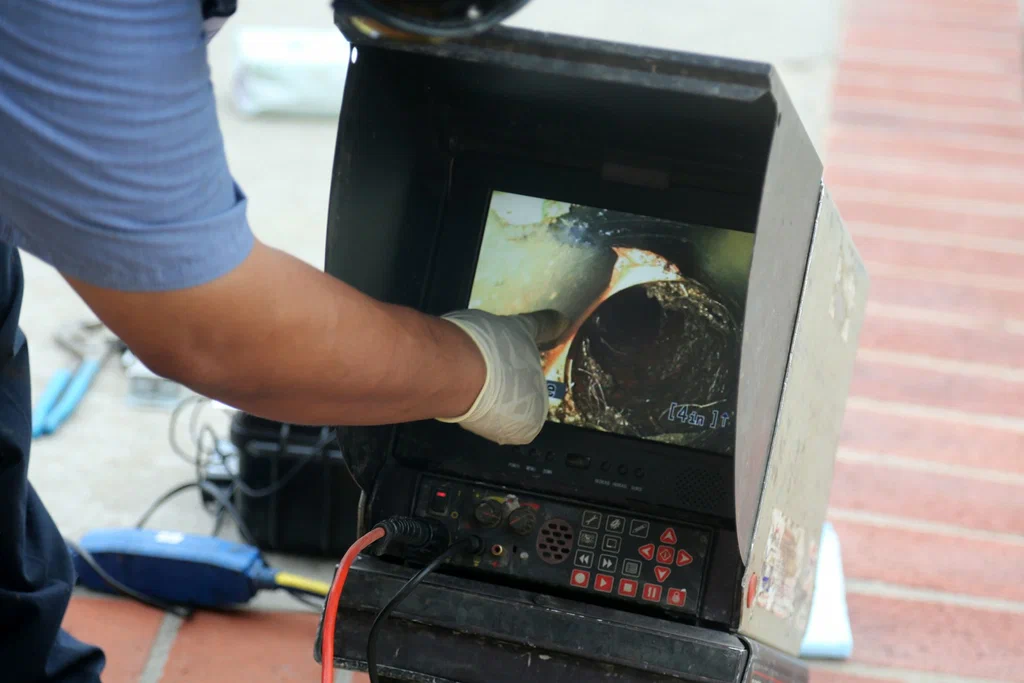 Technician viewing a drain inspection camera in Fleming Island