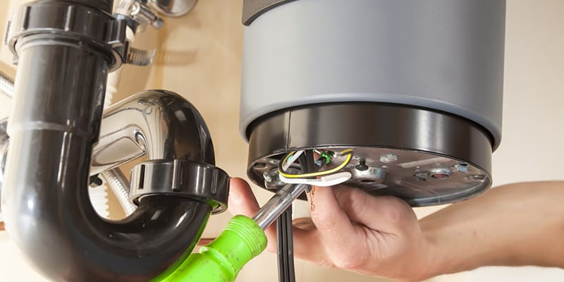 Technician repairing the heating element of a water heater in Fleming Island