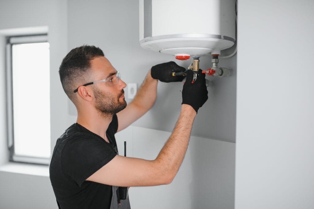 Technician performing water heater maintenance in Fleming Island