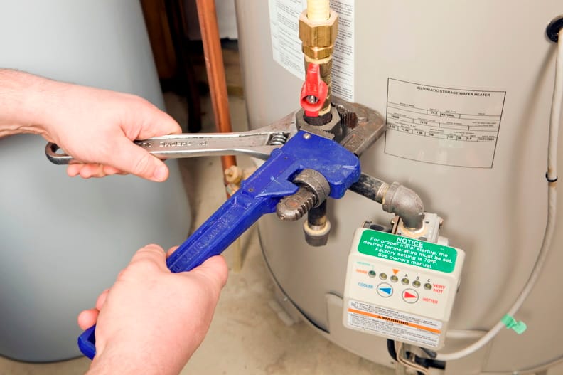 Plumber repairing a water heater valve in Fleming Island